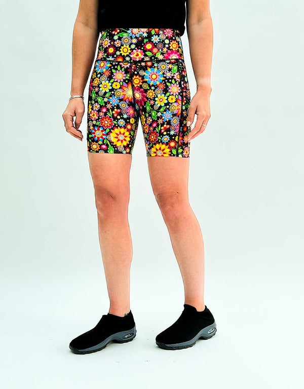Women's running shorts with vibrant rainbow floral print and deep side pockets for activewear and casual wear