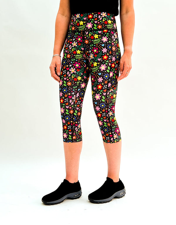 Colorful floral print leggings with high-rise waistband and side pockets, designed for comfort and activewear.