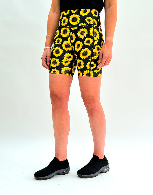Women's running shorts with vibrant sunflower print and deep side pockets for activewear and comfort