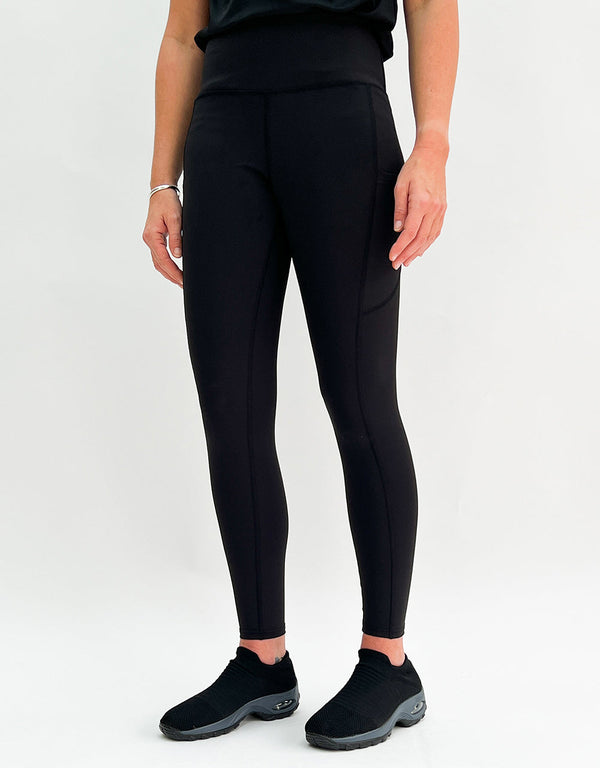 Black winter-lined gym leggings with side pockets and supportive waistband for cold-weather workouts