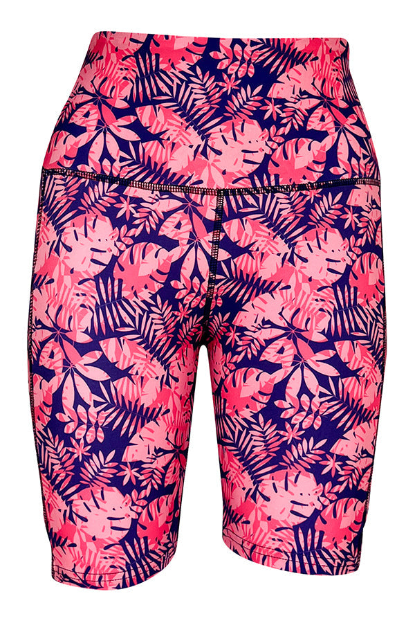 Tropical Oasis Shorts with bright pink palm leaf print, deep side pockets, and structured stitching on purple-blue background