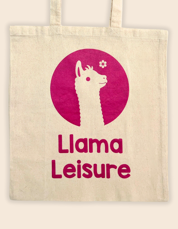 Beige llama tote bag with magenta llama graphic and "Llama Leisure" text