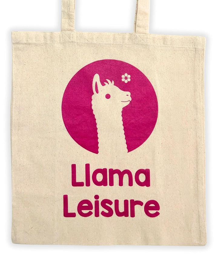 Beige tote bag with pink llama graphic and text "Llama Leisure" printed on front
