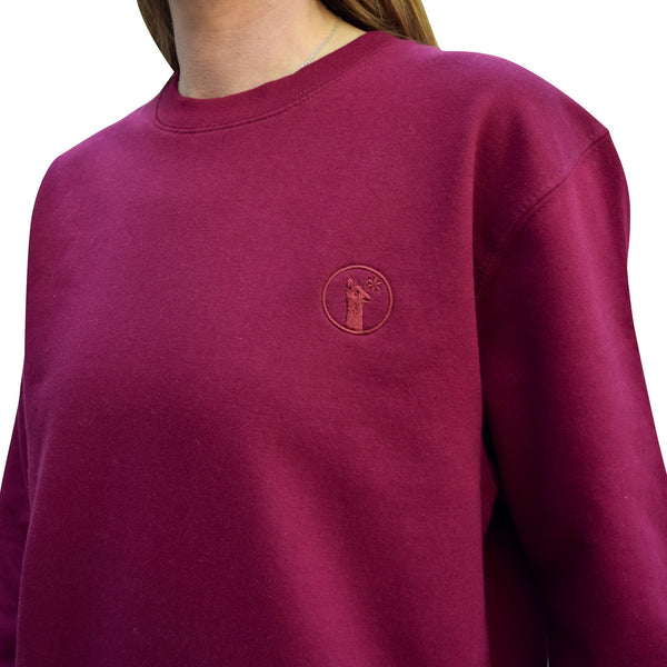 Burgundy sweatshirt with relaxed fit and subtle llama logo embroidered on chest, made of soft brushed fleece for warmth and comfort